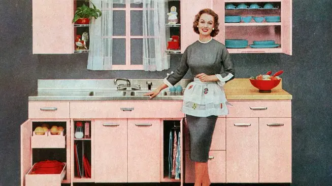 Vintage illustration of a fashionable 1950s housewife standing in front of her new pink kitchen. Screen print from an advertisement, 1957. --- Image by © PoodlesRock/Corbis