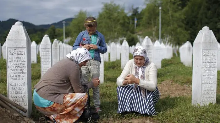 epa04990551 YEARENDER 2015 JULY A muslim women visit the Potocari Memorial Center in Srebrenica, Bosnia and Herzegovina, 10 July 2015. A total of 136 newly-identified Bosnian Muslims were buried on 11 July 2015 as part of a memorial ceremony to mark the 18th anniversary of the Srebrenica massacre. EPA/VALDRIN XHEMAJ