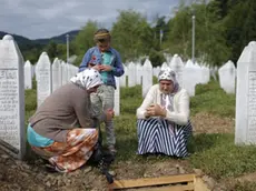 epa04990551 YEARENDER 2015 JULY A muslim women visit the Potocari Memorial Center in Srebrenica, Bosnia and Herzegovina, 10 July 2015. A total of 136 newly-identified Bosnian Muslims were buried on 11 July 2015 as part of a memorial ceremony to mark the 18th anniversary of the Srebrenica massacre. EPA/VALDRIN XHEMAJ