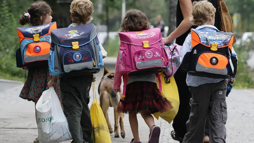 BERLIN - AUGUST 23: Children walk down the way on the first school day on August 23, 2010 in Berlin, Germany. Many German school districts, including those in Berlin, are reducing the school times pan from 13 to 12 years as part of a nationwide set of primary and secondary school reforms.. (Photo by Andreas Rentz/Getty Images)