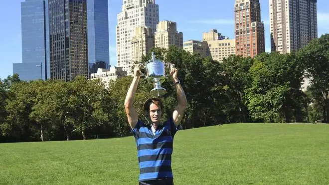 epa03394272 British tennis player Andy Murray poses for photographers with the trophy after winning the 2012 US Open men's tennis title in Central Park, New York, USA, 11 September 2012. Andy Murray rewrote 76 years of British tennis history as he won the first Grand Slam title on 10 September, defeating Novak Djokovic 7-6 (12-10), 7-5, 2-6, 3-6, 6-2. Murray took a huge weight off his shoulders as he became the first British man since Fred Perry to lift the trophy at a major. EPA/PETER FOLEY