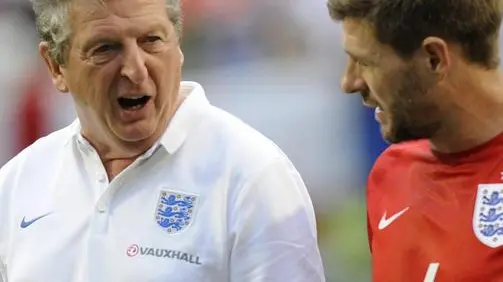 epa04244507 England's manager Roy Hodgson (L) exits the field with midfielder Steven Gerrard (R) during a weather delay during their international friendly match at Sun Life Stadium in Miami,Florida, USA, 07 June 2014. EPA/RHONA WISE