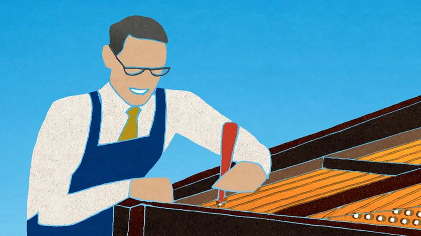 Worker tuning piano