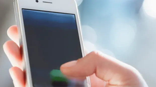 Young woman using smart phone, close up