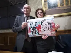 Claudio e Paola Regeni mostrano la foto di un murale fatto da writers egiziani su un muro di Berlino che raffigura il volto di Giulio Regeni con un gatto stilizzato durante la conferenza stampa all'interno della sala Nassiria a Palazzo Madama 4 aprile 2017 a Roma.ANSA/MASSIMO PERCOSSI