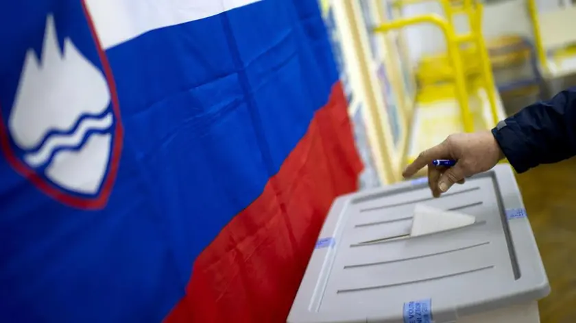 A voter casts his ballot at a polling station in Ljubljana, Slovenia, Sunday, Dec. 4, 2011. Slovenians vote in an early election Sunday expected to bring conservatives back to power, where they will have to tackle the country's mounting debt, unemployment and a looming recession. (AP Photo/Matej Leskovsek)