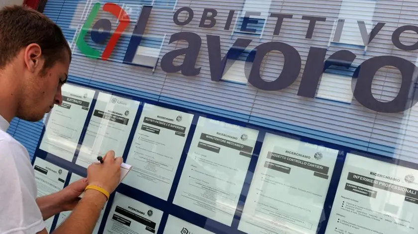 Un ragazzo davanti a una agenzia interinale mentre cerca un’occupazione
