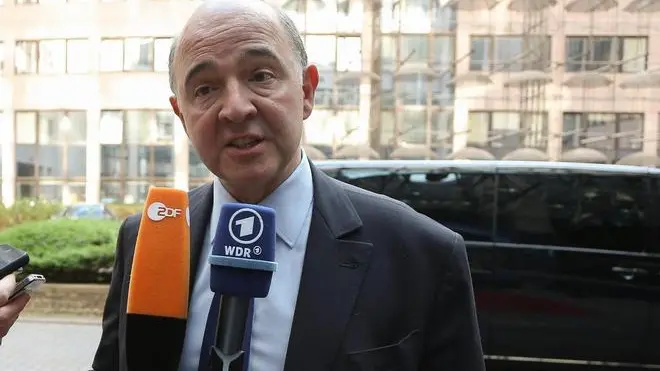 epa04118905 French Finance Minister Pierre Moscovici speaks to journalists as he arrives for a Eurogroup Finance Ministers meeting at the EU council headquarters in Brussels, Belgium, 10 March 2014. The Eurogroup is to discuss Winter 2014 European economic forecast by the European Commission, European Stability Mechanism (ESM) direct bank recapitalization instrument and economic adjustment programme in Cyprus, Greece and Portugal. EPA/JULIEN WARNAND