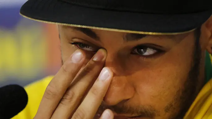 Brazil's Neymar wipes a tear during a press conference at the Granja Comary training center in Teresopolis, Brazil, Thursday, July 10, 2014. The Brazilian soccer star is back on his feet after suffering a broken vertebrae during a World Cup soccer match against Colombia. Brazil will be disputing a third place finish, without its star on Saturday. (AP Photo/Leo Correa)
