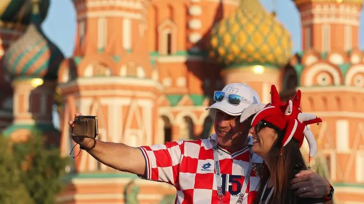 epa06884208 Supporters of Croatia pose for a selfie in front of the Saint Basil's Cathedral on the Red Square in central Moscow, Russia, 12 July 2018. Croatia will face France in their FIFA World Cup 2018 final in Moscow on 15 July 2018. EPA/ZURAB KURTSIKIDZE