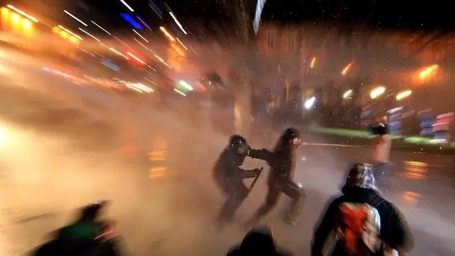 epa03492318 Police clash with protesters during an anti-government protest in Ljubljana, Slovenia, 30 November 2012. Thousands joined anti-government protests ahead of Slovenia's election run-off on 02 December 2012. The opposition Social Democratic leader Borut Pahor is expected to defeat incumbent non-partisan President Danilo Turk, opinion polls show. EPA/STR **SLOVENIA OUT**