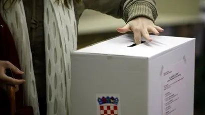 A voter casts her ballot at a polling station in Zagreb, Croatia, Sunday, Dec. 27, 2009. Croatians are voting for a new president Sunday in an election marked by allegations of corruption as the country tries to fight graft and smooth its entry into the European Union. (AP Photo/Darko Bandic)