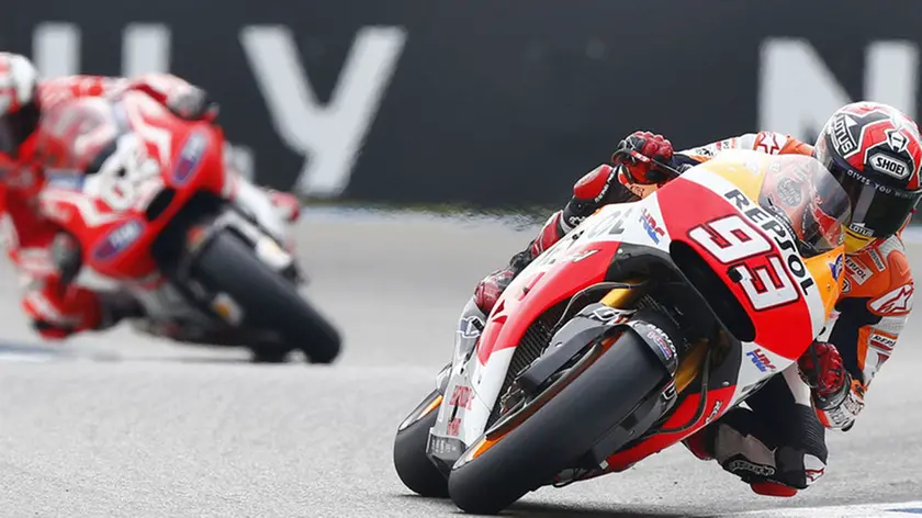 Marc Marquez of Spain in action on his Honda, right, competes with Andrea Dovizioso of Italy riding his Ducati during the MotoGP Race of the Dutch Grand Prix, in Assen, northern Netherlands, Saturday June 28, 2014. (AP Photo/Vincent Jannink)