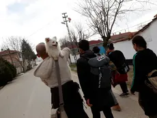 A man from Iran carries his dog as he walks with other migrants near Edirne at the Turkish-Greek border, Monday, March 9, 2020. Thousands of migrants have massed at Turkey\'s land border with EU-member Greece after Erdogan\'s government made good on a long-standing threat and announced that Turkey _ which is home to more than 3.5 million Syrian refugees _ would no longer prevent migrants and refugees from crossing over into EU countries. (AP Photo/Darko Bandic)