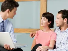 Couple meeting financial advisor --- Image by © Image Source/Corbis