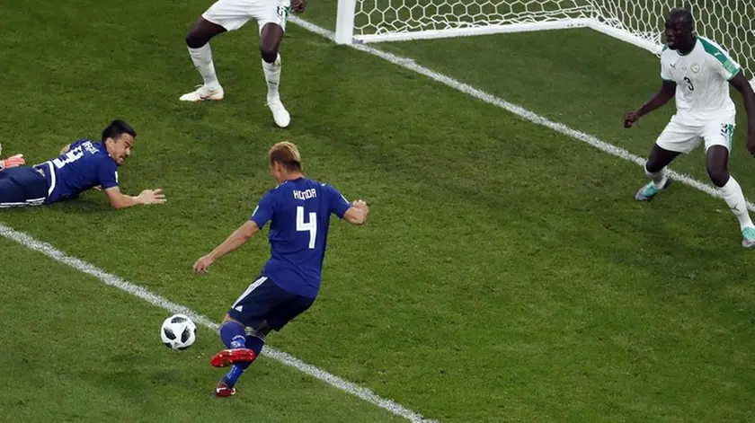 epa06836892 Keisuke Honda of Japan (4) scores the 2-2 during the FIFA World Cup 2018 group H preliminary round soccer match between Japan and Senegal in Ekaterinburg, Russia, 24 June 2018. (RESTRICTIONS APPLY: Editorial Use Only, not used in association with any commercial entity - Images must not be used in any form of alert service or push service of any kind including via mobile alert services, downloads to mobile devices or MMS messaging - Images must appear as still images and must not emulate match action video footage - No alteration is made to, and no text or image is superimposed over, any published image which: (a) intentionally obscures or removes a sponsor identification image; or (b) adds or overlays the commercial identification of any third party which is not officially associated with the FIFA World Cup) EPA/ROMAN PILIPEY EDITORIAL USE ONLY EDITORIAL USE ONLY EPA-EFE/ROMAN PILIPEY EDITORIAL USE ONLY EDITORIAL USE ONLY EDITORIAL USE ONLY