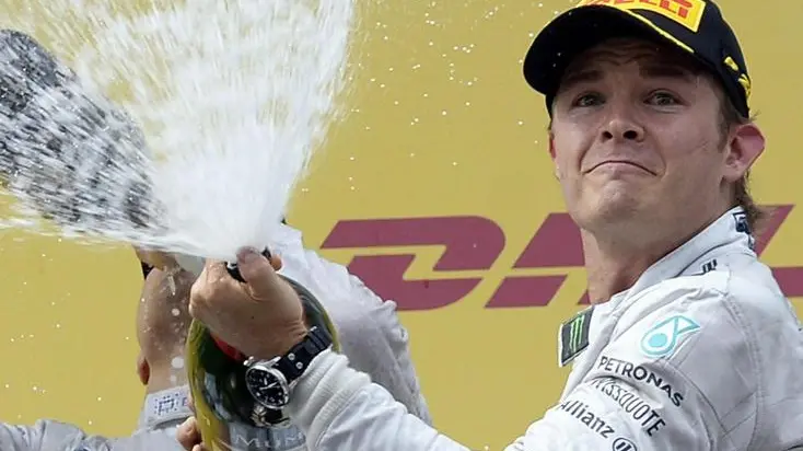 epaselect epa04272471 German Formula One driver Nico Rosberg of Mercedes AMG Petronas F1 Team (R) celebrates his victory with champagne on the podium next to thrid-placed Finnish Formula One driver Valtteri Bottas of Williams F1 Racing (L) after the Formula One Grand Prix of Austria at the Red Bull Ring in Spielberg, Austria, 22 June 2014. EPA/HANS KLAUS TECHT
