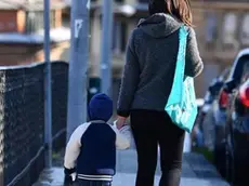 One of the very few mothers with her baby traveling around the city, Genova, Italy, 30 March 2020. Countries around the world are taking measures to stem the widespread of the SARS-CoV-2 coronavirus which causes the Covid-19 disease. ANSA/LUCA ZENNARO