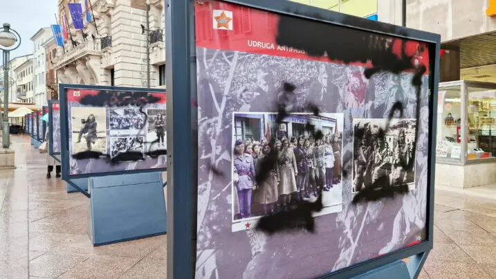 Uno dei pannelli della mostra “Partizanke” lordato dai vandali a Fiume