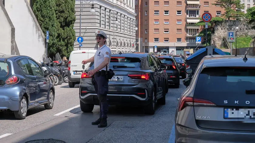 Le auto incolonnate in via del Teatro Romano e un agente che tenta di regolare il traffico (Silvano)