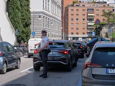 Le auto incolonnate in via del Teatro Romano e un agente che tenta di regolare il traffico (Silvano)