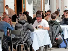Persone a tavola in un ristorante di Trieste in una foto d’archivio