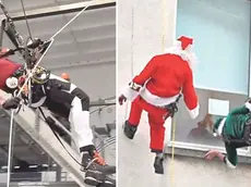 Tommaso Andreuzza al lavoro e mentre si cala con le funi vestito da Babbo Natale