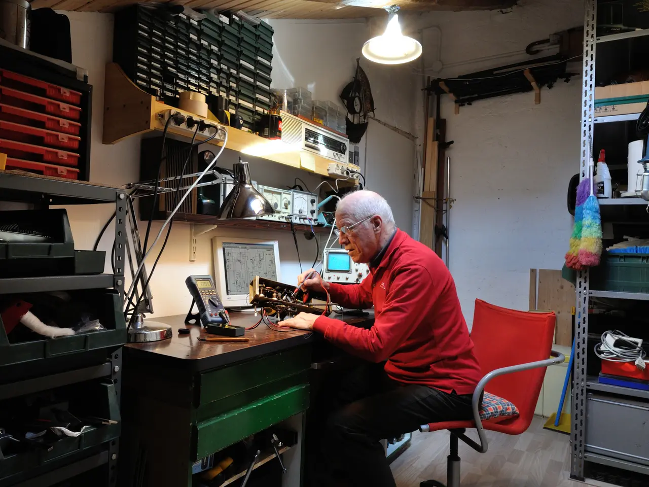 Paolo Fachin al lavoro mentre sistema un vecchio apparecchio radiofonico