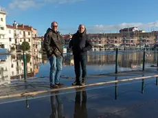 Luca e Michele Mariocco davanti al porto con l’acqua alta che si sta ritirando