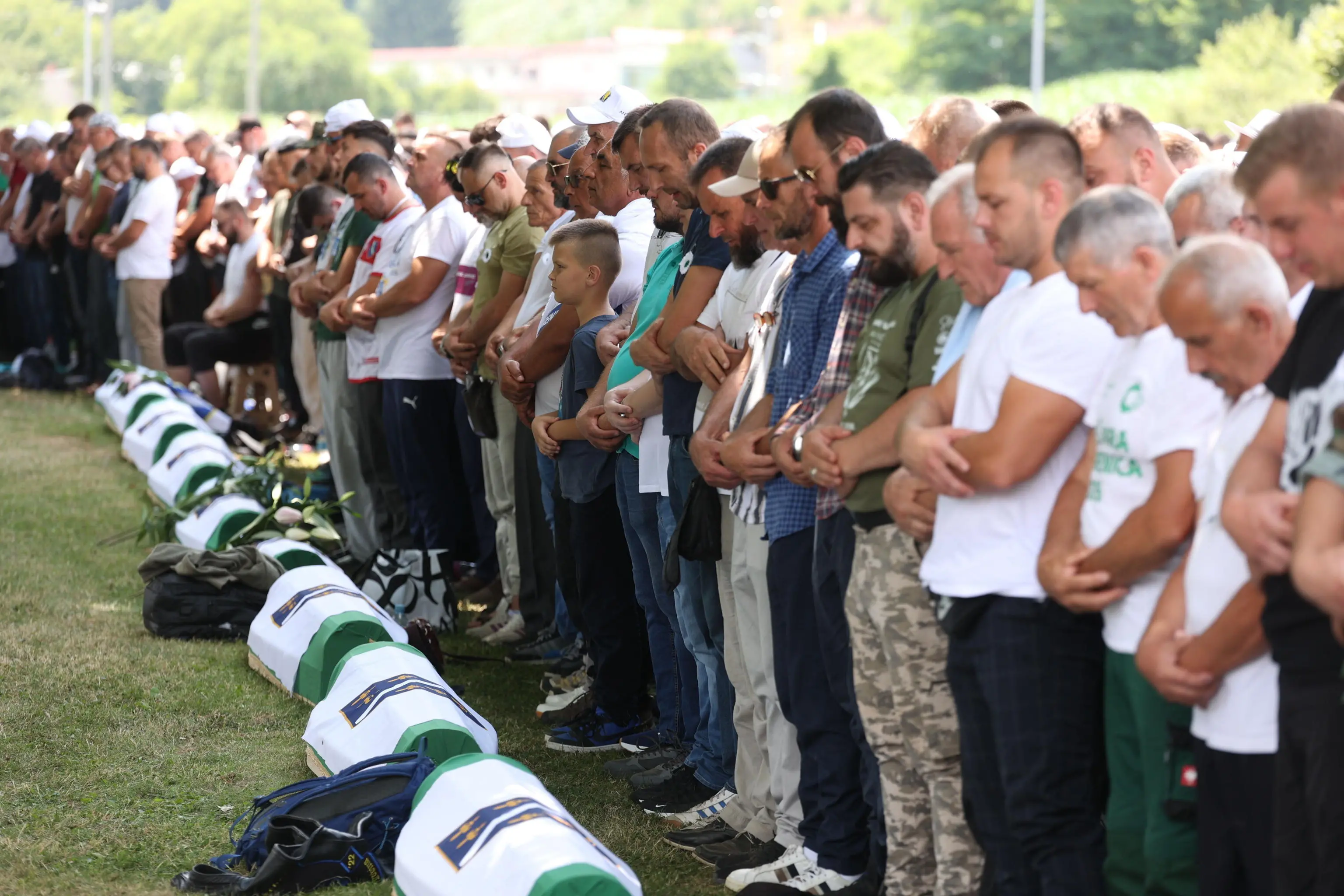 epa13104545 Bosnian Muslims mourn next to caskets with the remains of newly-identified Bosnian Muslim victims of Srebrenica genocide, during a funeral ceremony at the Potocari Memorial Center and Cemetery, in Srebrenica, Bosnia and Herzegovina, 11 July 2026. The burial is part of a memorial ceremony to mark the 31st anniversary of the Srebrenica genocide, considered the worst atrocity of Bosnia's 1992-95 war. More than 8,000 Muslim men and boys were executed in the 1995 killing spree after Bosnian Serb forces overran the town.town. EPA/HAZIM ALJOVIC BOSNIA AND HERZEGOVINA OUT