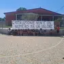 I bambini della scuola e lo striscione con il messaggio di protesta