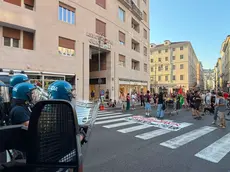 I manifestanti vicino alla Questura blindata dagli agenti anti-sommossa (Silvano)