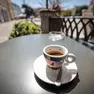 Una tazzina di caffè su un tavolino di un bar del centro (Tibaldi)