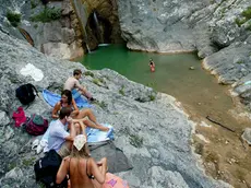 Alcuni ragazzi fanno il bagno nelle pozze del torrente Rosandra