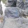 Una delle pietre della Val Rosandar imbrattate dai vandali