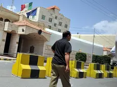 epa03325917 A Yemeni man passes the Italian embassy a day after an Italian officer was kidnapped in Sana'a, Yemen, 30 July 2012. According to media reports, an Italian officer was kidnapped on 29 July in front of the Italian embassy in the Yemeni capital Sana'a by armed men. The man was responsible for security issues at the embassy. EPA/YAHYA ARHAB