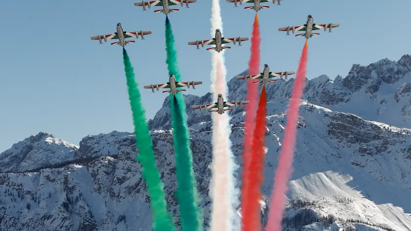 Jets of the "Frecce Tricolori" (Tri-Color Arrows) aerobatics team of the Italian Air Force fly over Cortina D'Ampezzo, Italy, prior to the men's downhill, at the alpine ski World Championships, Sunday, Feb.14, 2021. (AP Photo/Gabriele Facciotti)