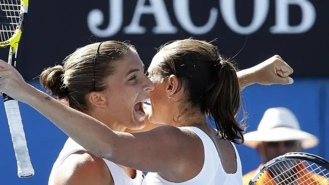 epa03549553 Italian double Sara Errani (L) and Roberta Vinci celebrate after winning their 4th round doubles match against Venus and Serena Williams at the Australian Open Grand Slam tennis tournament in Melbourne, Australia, 22 January 2013. EPA/Narendra Shrestha