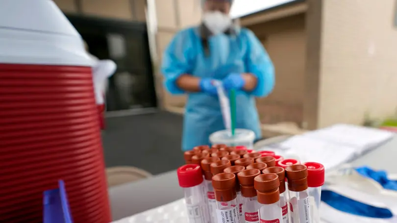 Test kits sit on a table as healthcare professional Kenzie Anderson prepares to take a sample at a United Memorial Medical Center COVID-19 testing site Friday, June 26, 2020, in Houston. The number of COVID-19 cases continues to rise across the state. Texas Gov. Greg Abbott has said that the state is facing a \"massive outbreak\" in the coronavirus pandemic and that some new local restrictions may be needed to protect hospital space for new patients. (AP Photo/David J. Phillip)