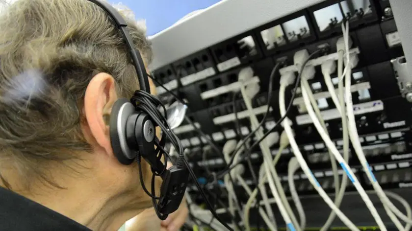 Un tecnico al lavoro con una centralina telefonica. ANSA/FRANCO SILVI