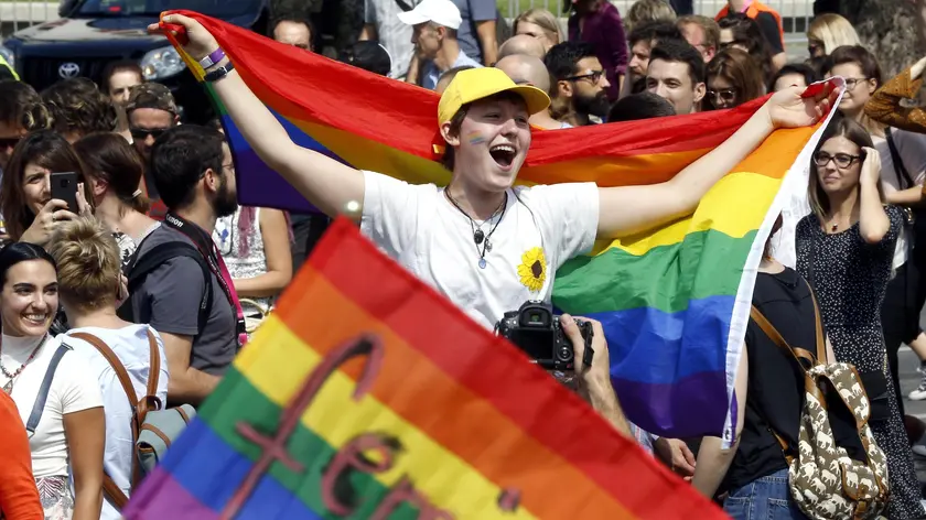 epa07827712 Participants carry placards and rainbow colored flags during Sarajevo's first-ever gay pride parade, in Sarajevo, Bosnia and Herzegovina, 08 September 2019. Representatives of LGBT (Lesbian, Gay, Bisexual and Transgender) organisations and their supporters took part in the event that also commemorates the 50th anniversary of the so-called Stonewall Riots in New York City, USA, when a police raid at the Stonewall Inn in Greenwich Village in 1969 sparked riots that were leading to the gay liberation movement. EPA/FEHIM DEMIR