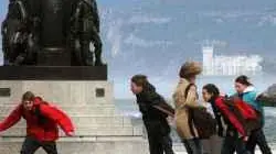 20051229 - TRIESTE - TURISMO: A TRIESTE UNA GUIDA AI ''LUOGHI DELLA BORA''. Nell'immagine d'archivio (aprile 2005) un gruppo di ragazzi ripresi stamane in Piazza dell'Unità a Trieste, sfida la forza dela bora. ANDREA LASORTE - ANSA archivio - JI