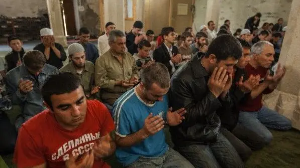 14 May 2010 --- Crimean Tatars gather for Friday prayer in the Khan Uzbek Mosque. Built in 1314, it is the oldest remaining mosque in Crimea and is located in the town of Stari Krym, host to the largest percentage of Tatars in Crimea (ca. 45%). --- Image by © Jerome Levitch/Corbis