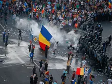 Protesters stand in front of police during a demonstration in Bucharest, Romania, August 10, 2018. Inquam Photos/Adriana Neagoe via REUTERS ATTENTION EDITORS - THIS IMAGE WAS PROVIDED BY A THIRD PARTY. ROMANIA OUT.