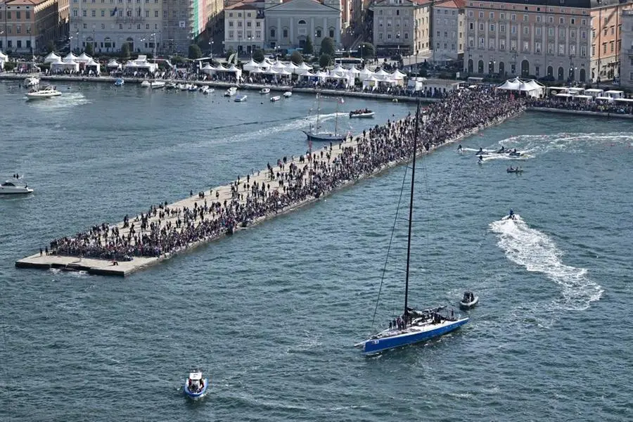 An aerial view shows the Deep Blue, which went on to win the regatta, motoring past the pier of the port of Trieste for the 54st Barcolana regatta in the Gulf of Trieste on October 9, 2022. - With almost 2000 vessels, the Barcolana has the most particpants of any sailing regatta in the world. The Deep Blue ship won the 54st regatta. (Photo by Andreas SOLARO / AFP) (Photo by ANDREAS SOLARO/AFP via Getty Images)