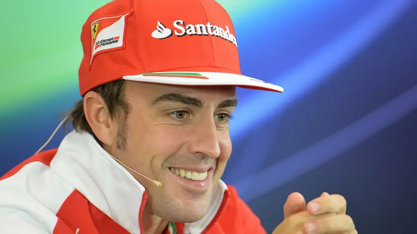 Ferrari driver Fernando Alonso of Spain smiles during a press conference in Spielberg, Austrian province of Styria, Thursday, June 19, 2014. The Austria Formula One Grand Prix will be held on Sunday. (AP Photo/Kerstin Joensson)