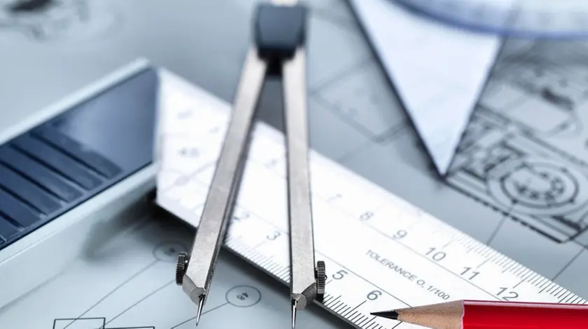 Drawing equipment sitting on engineering drawing