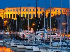 13 May 2007, Pula --- Dusk over marina and the Roman Amphitheatre, Pula, Istria, Croatia, Adriatic, Europe --- Image by © Stuart Black/Robert Harding World Imagery/Corbis