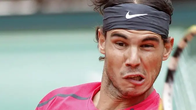 epa03259410 Rafael Nadal of Spain returns to Novak Djokovic of Serbia during their final match for the French Open tennis tournament at Roland Garros in Paris, France, 11 June 2012. EPA/IAN LANGSDON