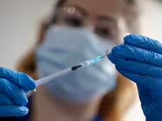 A nurse prepares a shot of the Pfizer-BioNTech COVID-19 vaccine at Guy's Hospital in London, Tuesday, Dec. 8, 2020, as the U.K. health authorities rolled out a national mass vaccination program. U.K. regulators said Wednesday Dec. 9, 2020, that people who have a “significant history’’ of allergic reactions shouldn’t receive the new Pfizer/BioNTech vaccine while they investigate two adverse reactions that occurred on the first day of the country’s mass vaccination program. (AP Photo/Frank Augstein, Pool)